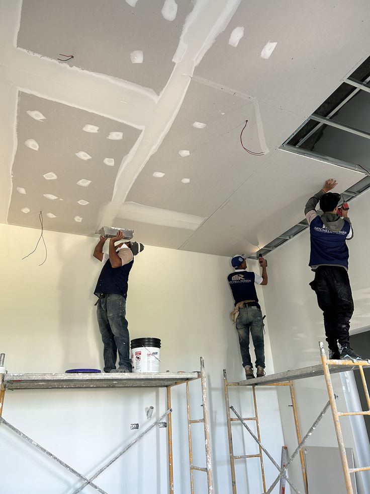 Pinnacle Pro crew finishing a commercial ceiling from scaffolding