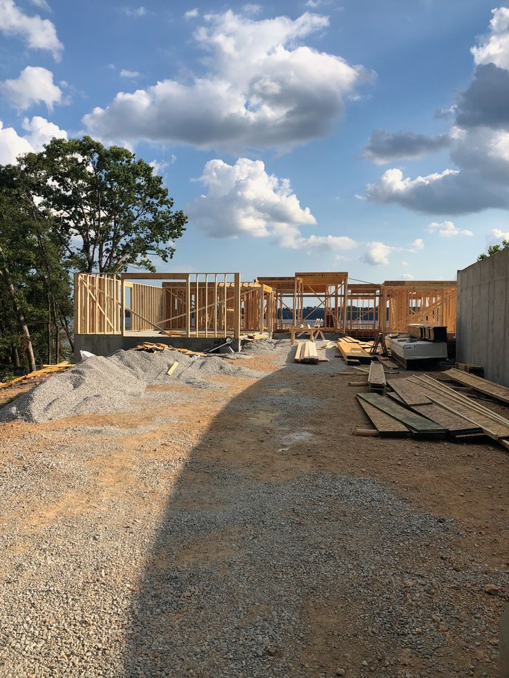 Ground-up framing on a poured foundation at a hillside job site